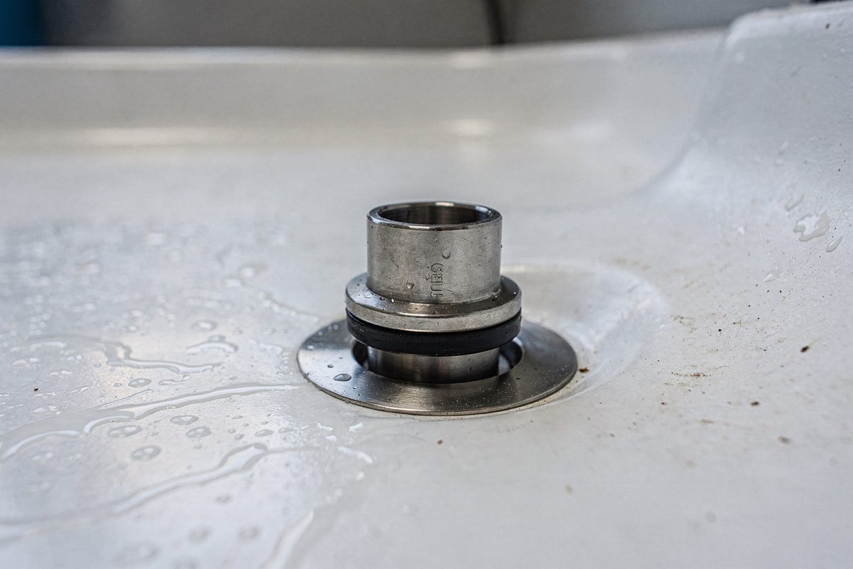 Drain valve kit installed in the floor of a grooming tub